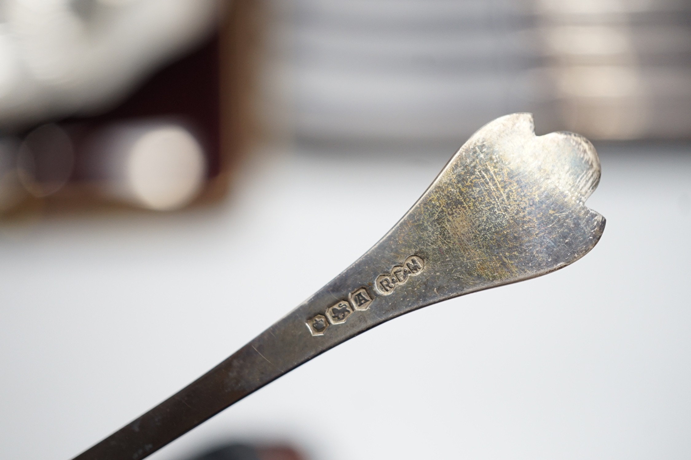 A set of six tea knives, an Edwardian silver butter shell and knife and a set of six silver coffee spoons, all cased.